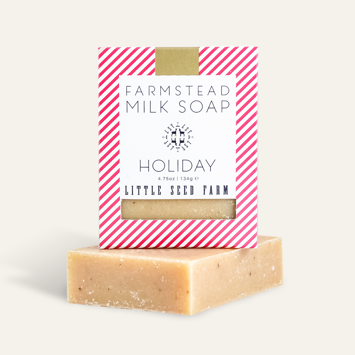 a bar of little seed farm holiday goats milk soap with the box sitting on top of it.