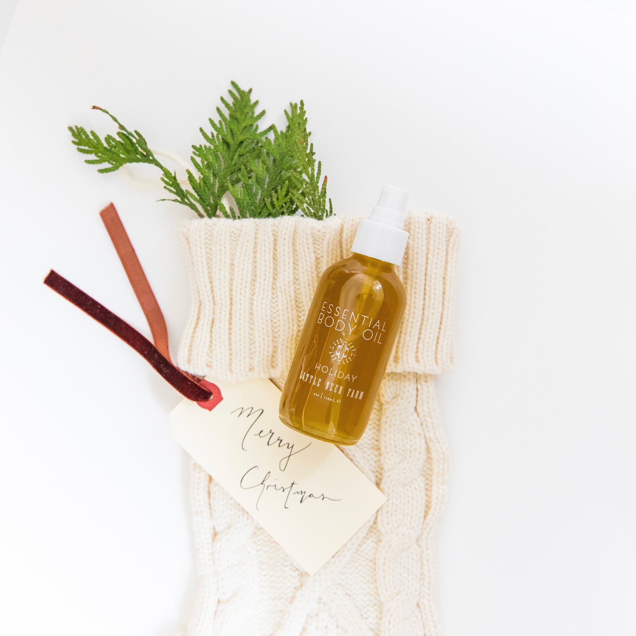 Holiday Body Oil in a festive peppermint-vanilla scent, gently nourishing skin from head to toe with botanical oils that support hydration and softness.