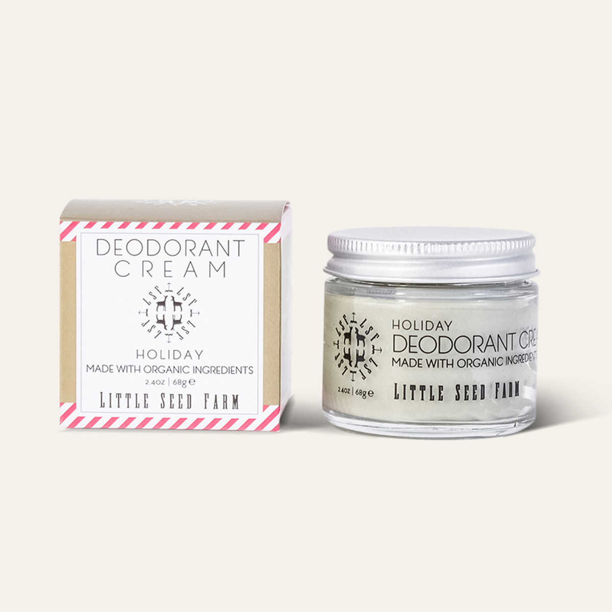 Close-up of Holiday Deodorant Cream texture inside jar, creamy light tone with fine granules showing activated charcoal blend