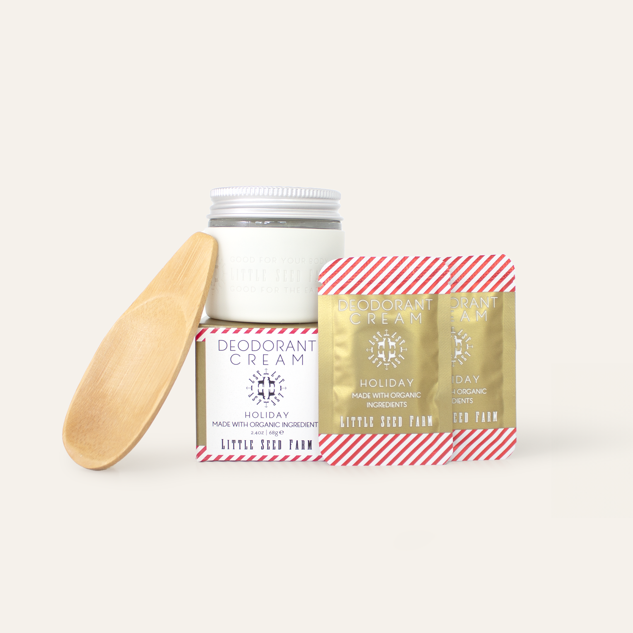 The holiday scent stater kit including the holiday deodorant cream, a white silicone sleeve, an applicator and two holiday sample packets.