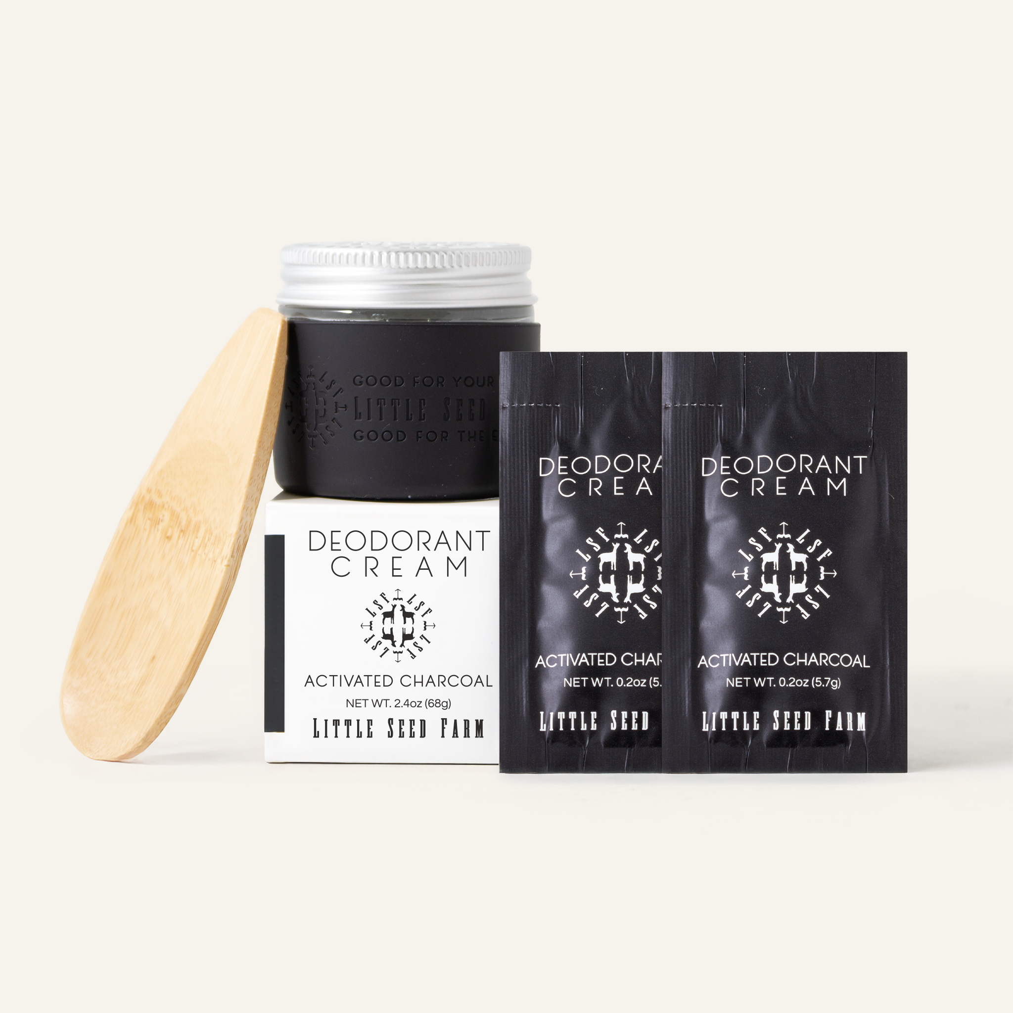 The Little Seed Farm Activated Charcoal Deodorant starter kit, including the deodorant, two deodorant samples, a black silicone sleeve and a deodorant applicator.