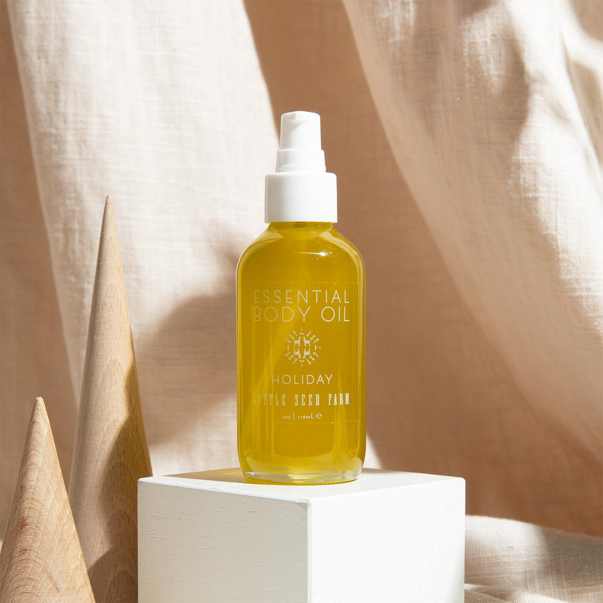 Holiday Body Oil in a festive peppermint-vanilla scent, gently nourishing skin from head to toe with botanical oils that support hydration and softness.
