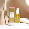 Holiday Body Oil in a festive peppermint-vanilla scent, gently nourishing skin from head to toe with botanical oils that support hydration and softness.
