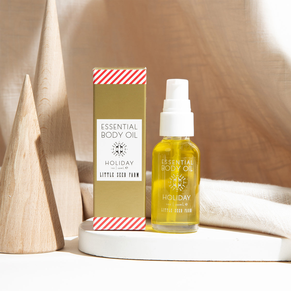 Holiday Body Oil in a festive peppermint-vanilla scent, gently nourishing skin from head to toe with botanical oils that support hydration and softness.
