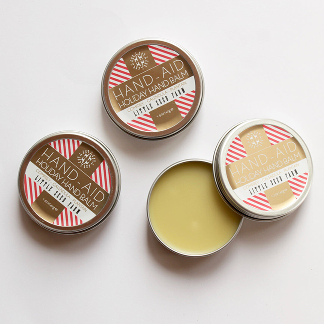 a group of little seed farm hand aid tins.