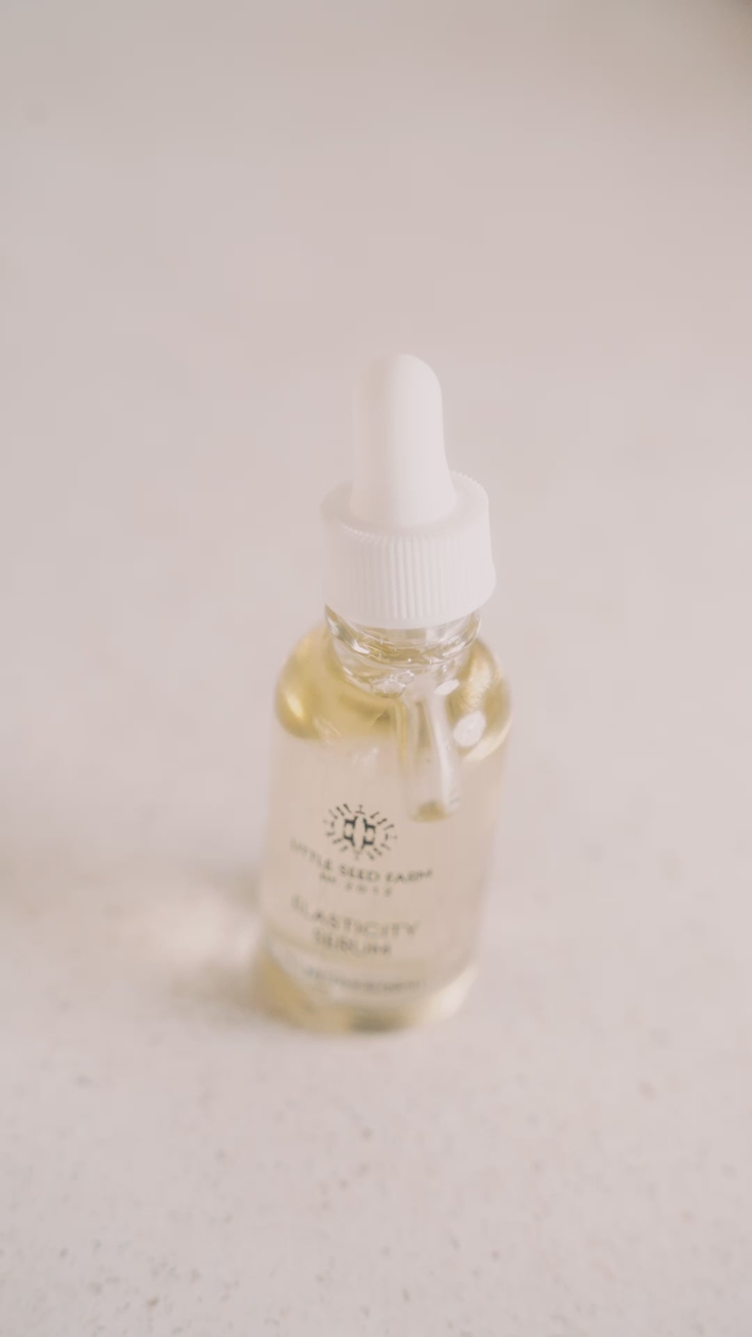 Little Seed Farm Hazelnut Rosemary Elasticity Serum formulated with virgin hazelnut oil and an organic essential oil blend to moisturize, tone, enhance skin elasticity, reduce fine lines and hyperpigmentation, and leave a glowing finish